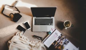 workspace with laptop and book