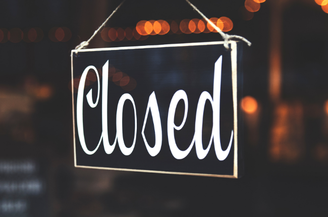 Closed sign hanging in shop window