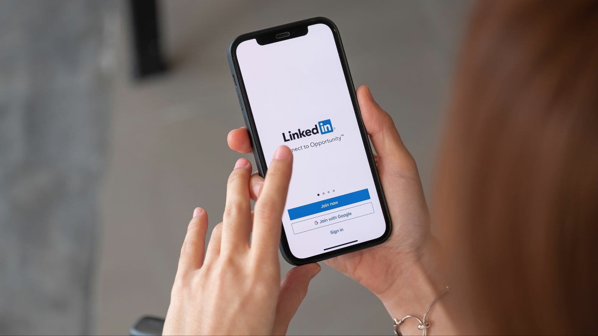 Person holding phone with LinkedIn open