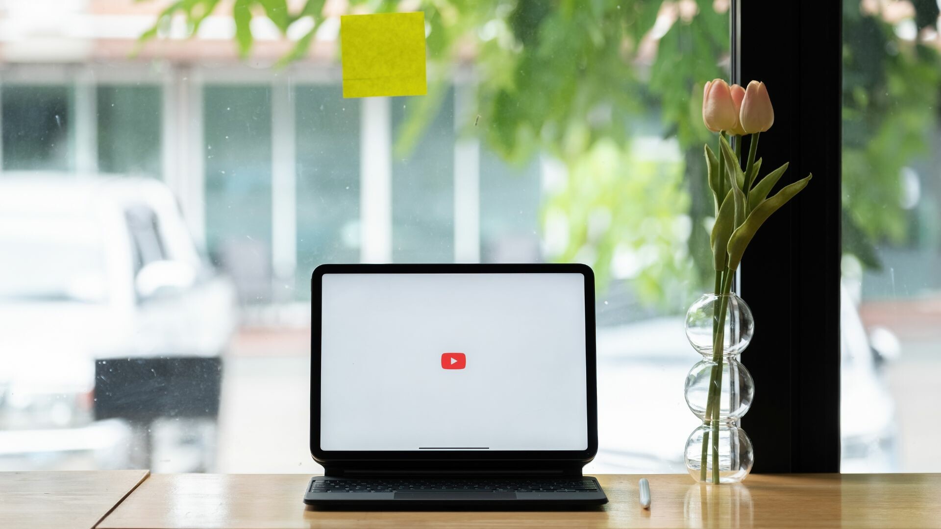 YouTube logo on an iPad by a window.