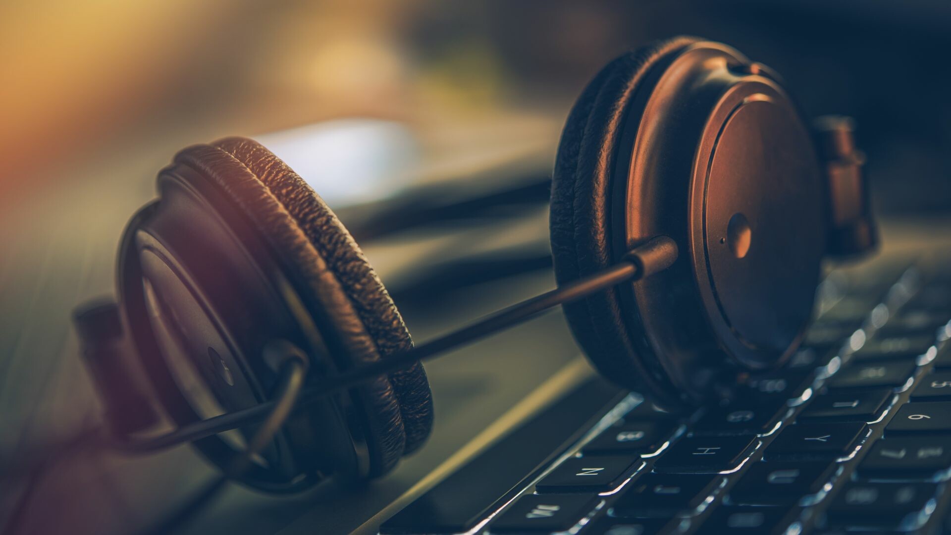 Headphones resting on a keyboard.
