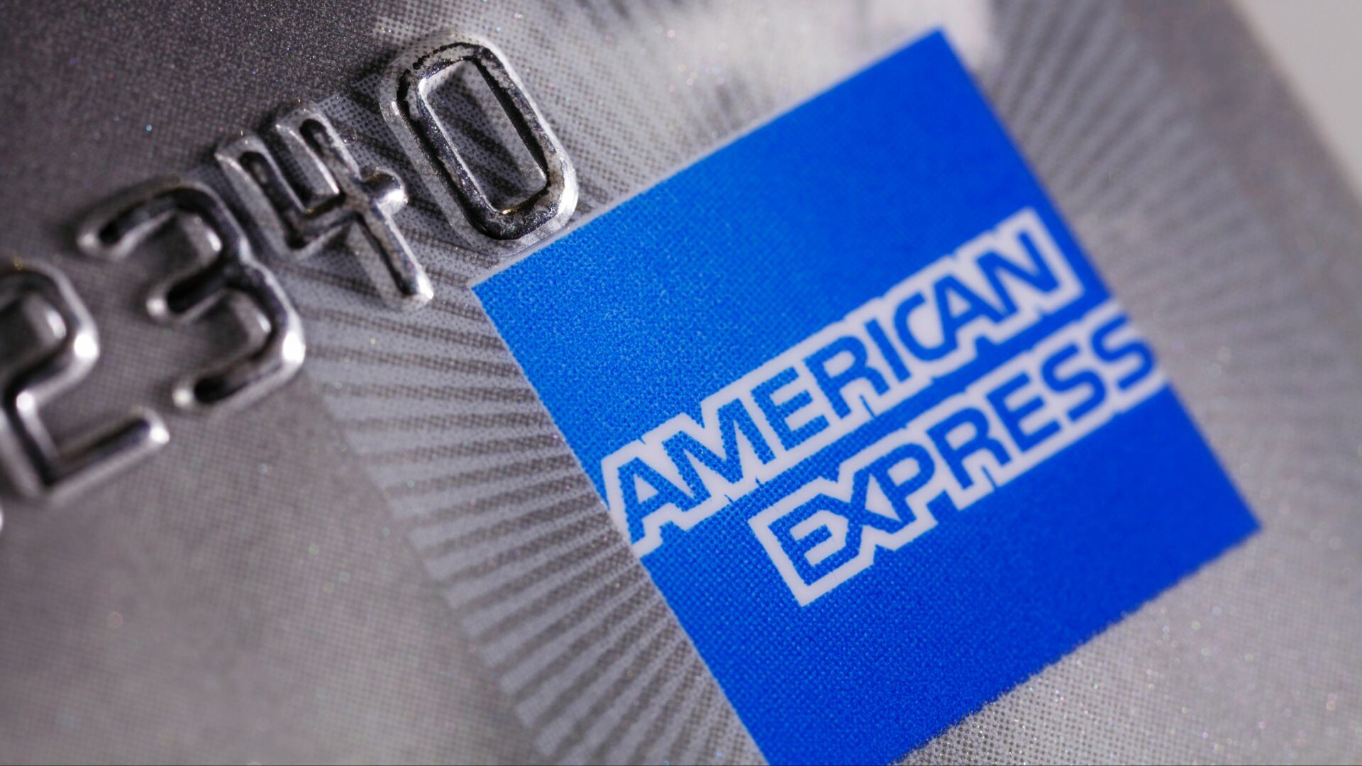 Close of of the American Express logo on a credit card.