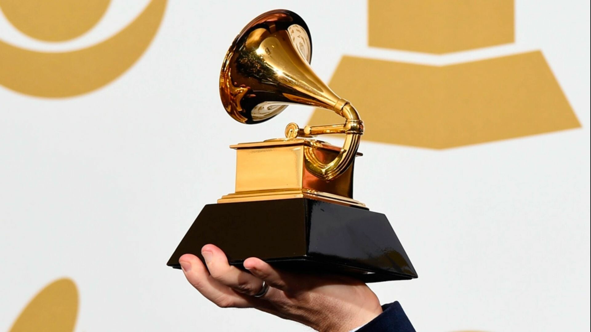 Person holding a Grammy.