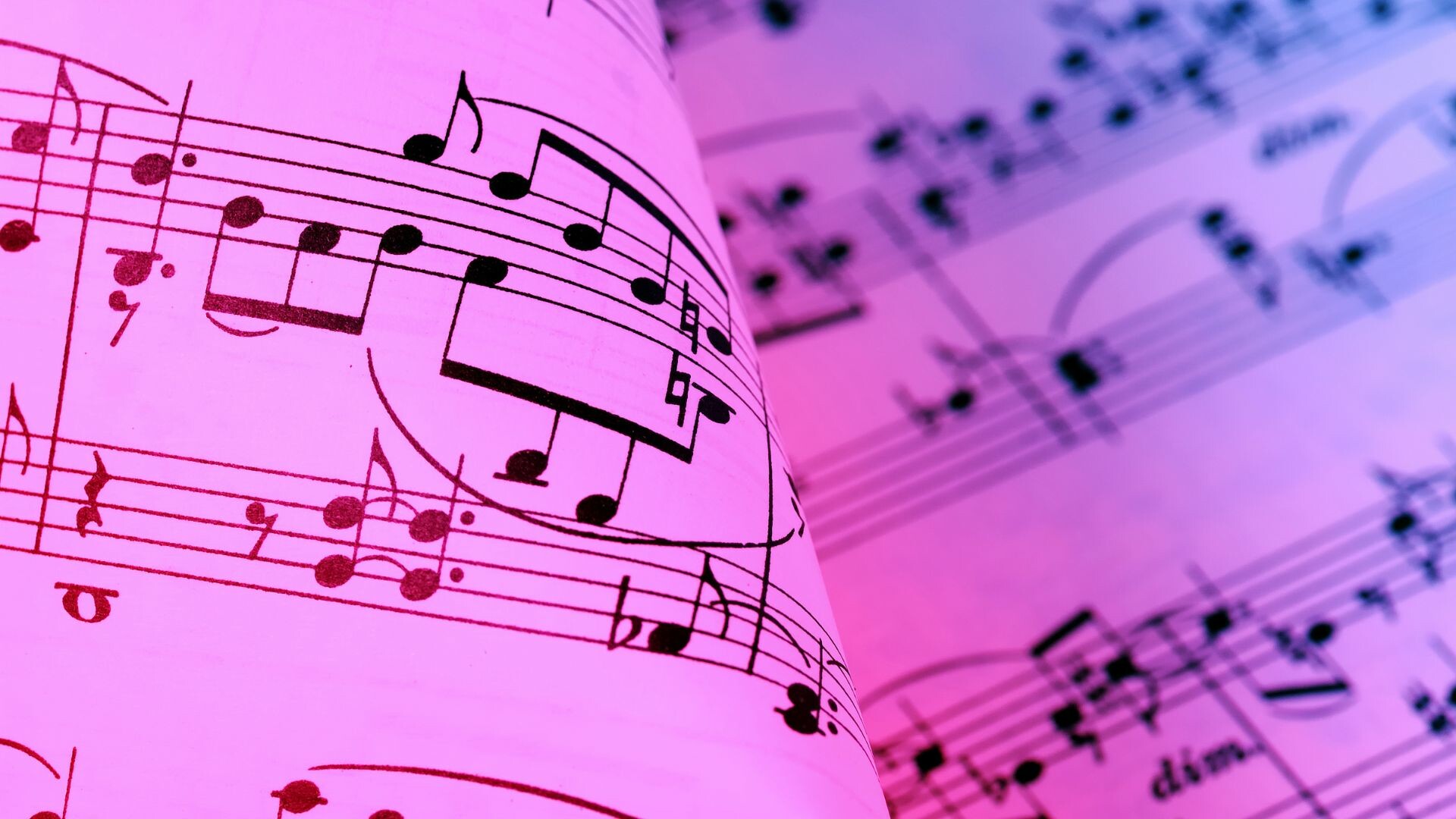 Sheet music illuminated in blue and red light.