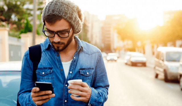 Man on cell phone checking social media