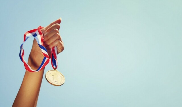 Hand holding medal