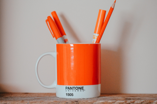 Orange Cup holding brand guidelines for content strategy