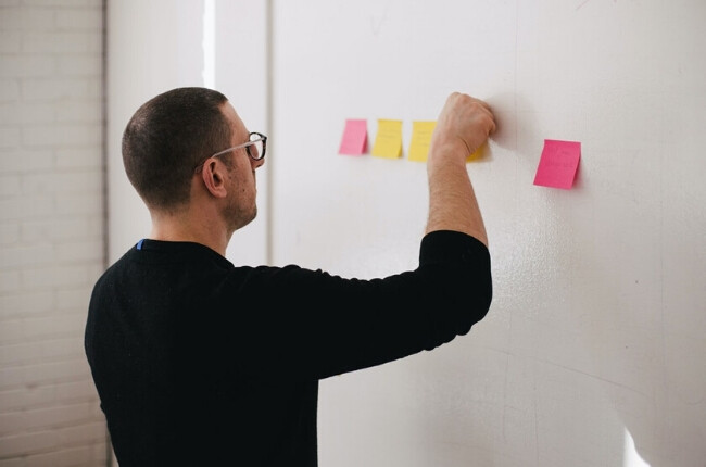 man choosing the right KPIs with stickie notes
