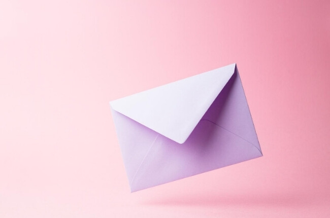 white envelope on a pink background