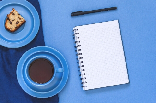 white notepad on blue table