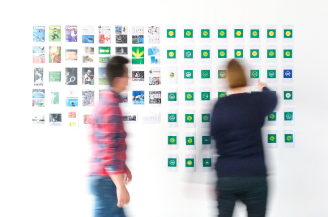 Two people in front of whiteboard with sticky notes