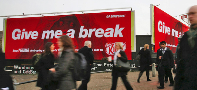 Billboards with image of orangutan and words "Give me a break"