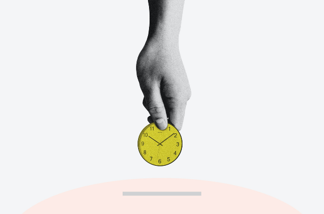 Hand holding a yellow clock