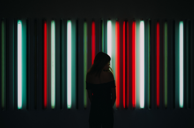Silhouette of person in red and white neon lights