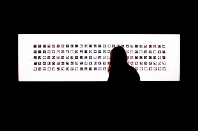 Silhouette of a person in front of white lit rectangle