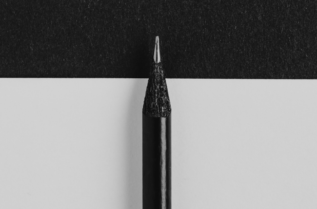 Black pencil on black and white paper