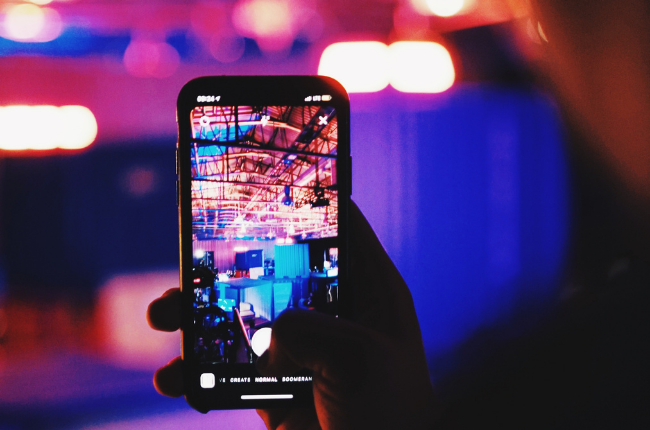 Person taking Instagram Story of event