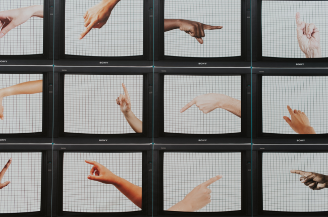 TV sets with fingers pointing in different directions