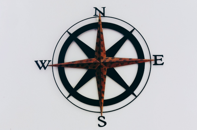 Brown and black compass on white background