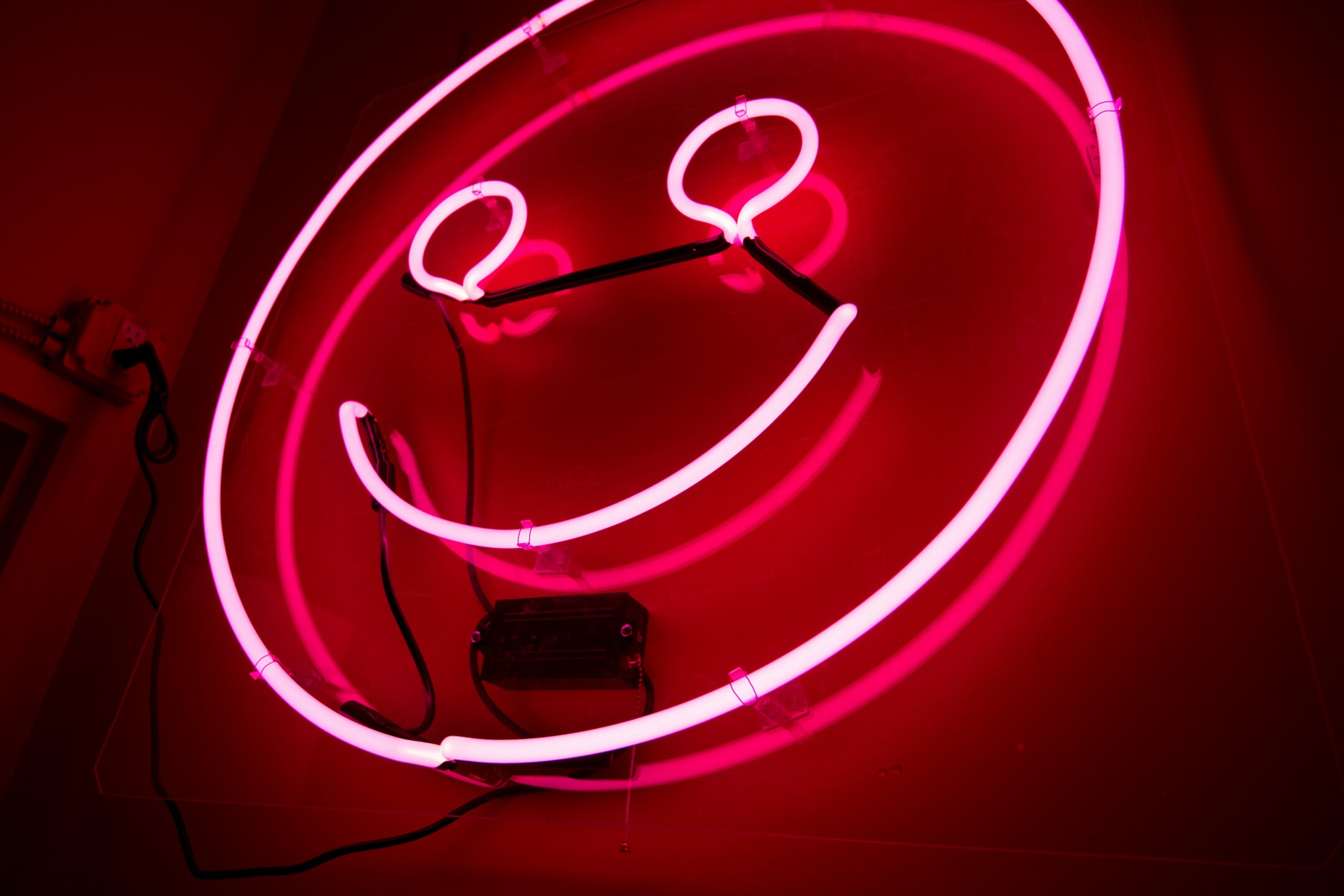 neon pink happy face sign