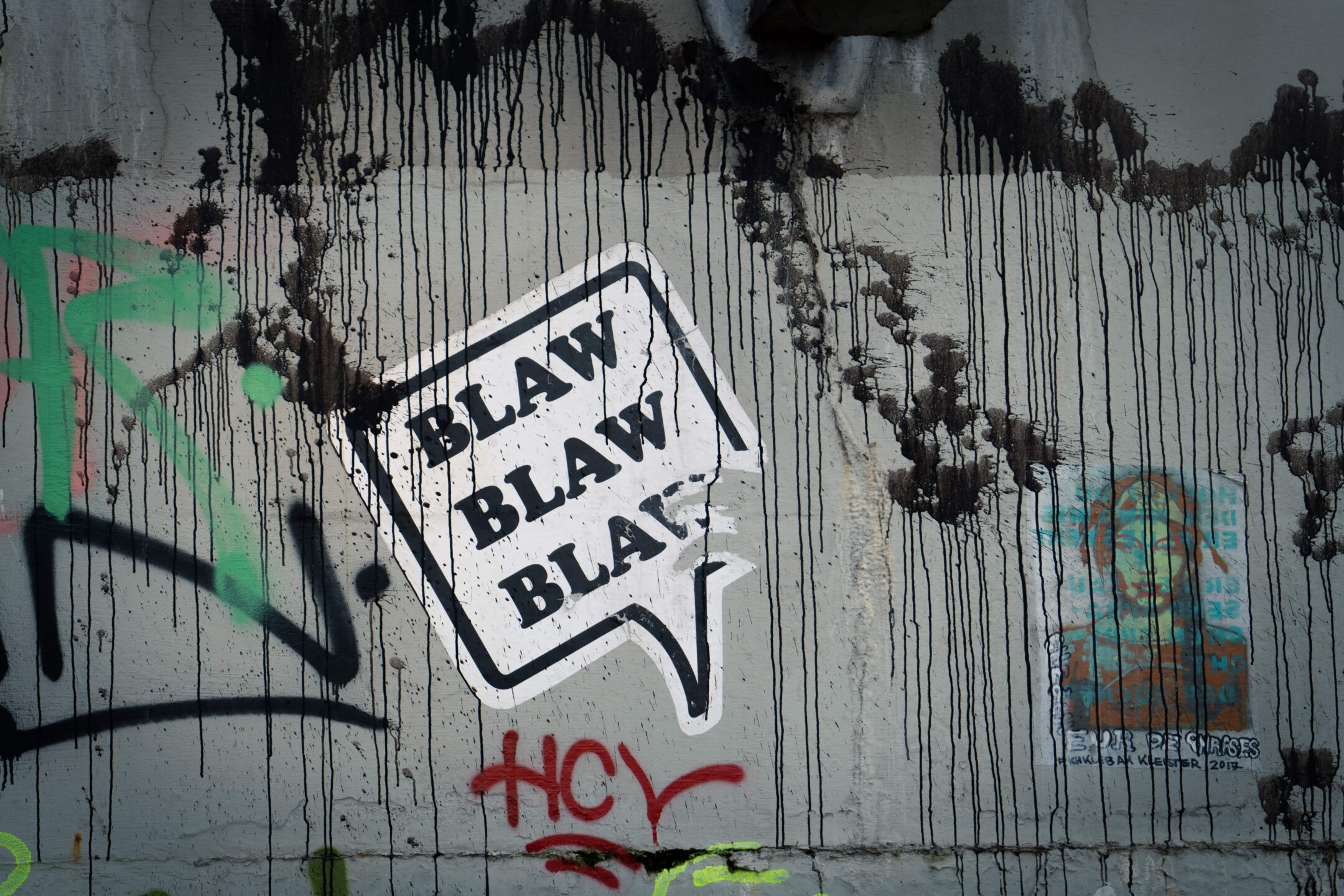 Blah sticker on graffiti wall